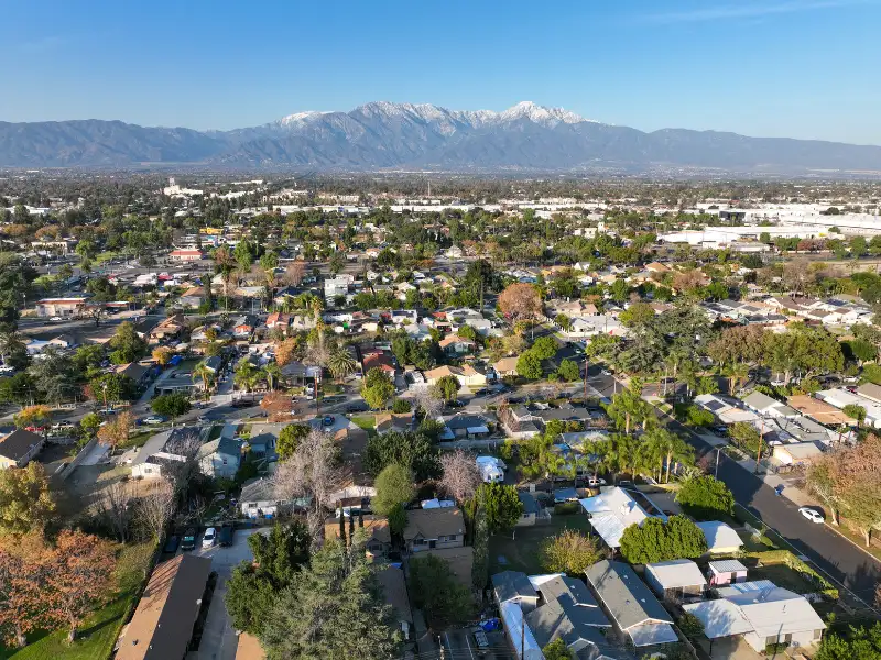 Aerial view of a suburban neighborhood with mountains in the background.