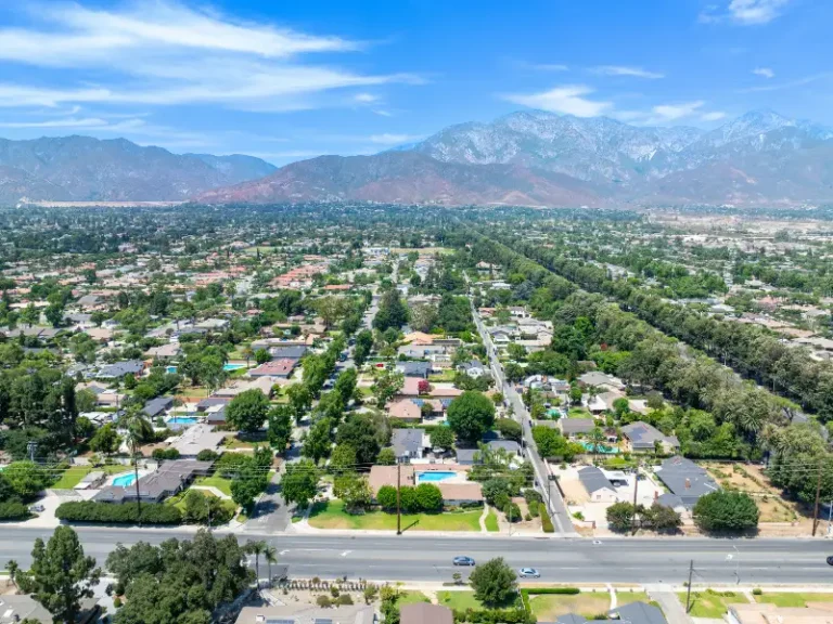 Aerial view of a suburban neighborhood with mountains in the background.